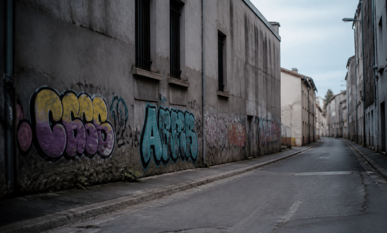 Rue déserte avec immeubles gris décorés de tags colorés